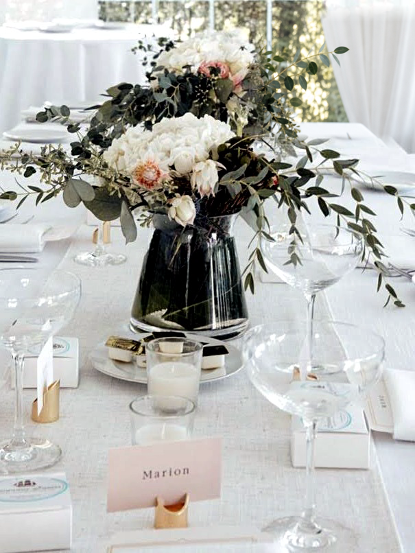 A flower arrangement on a set dining table